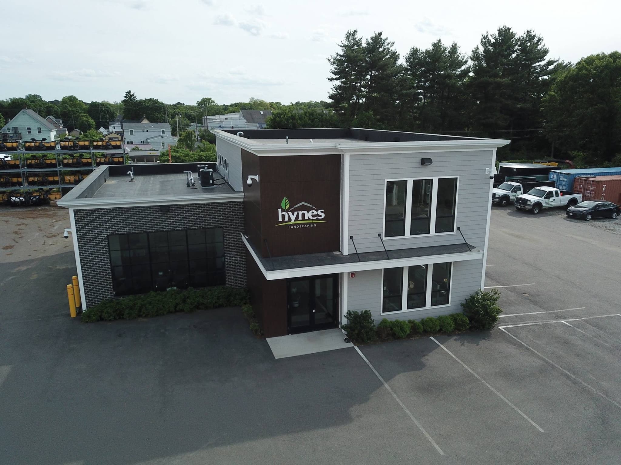 Hynes Landscaping headquarters at 118 Cushing Street, Stoughton, MA — branded two-story office with fleet yard