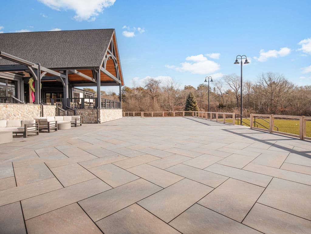 Split-rail perimeter fencing along the bluestone terrace at Love Farms in West Dennis, MA